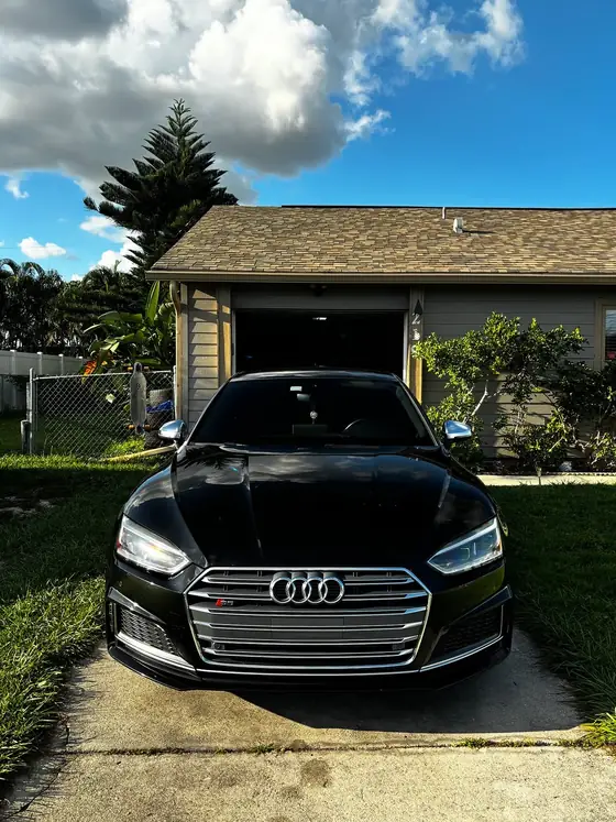 Black Audi S5 front end with mirror-like paint after full detail