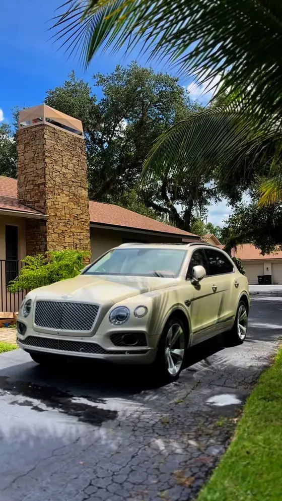 Bentley Bentayga glistening in a driveway after a full detail