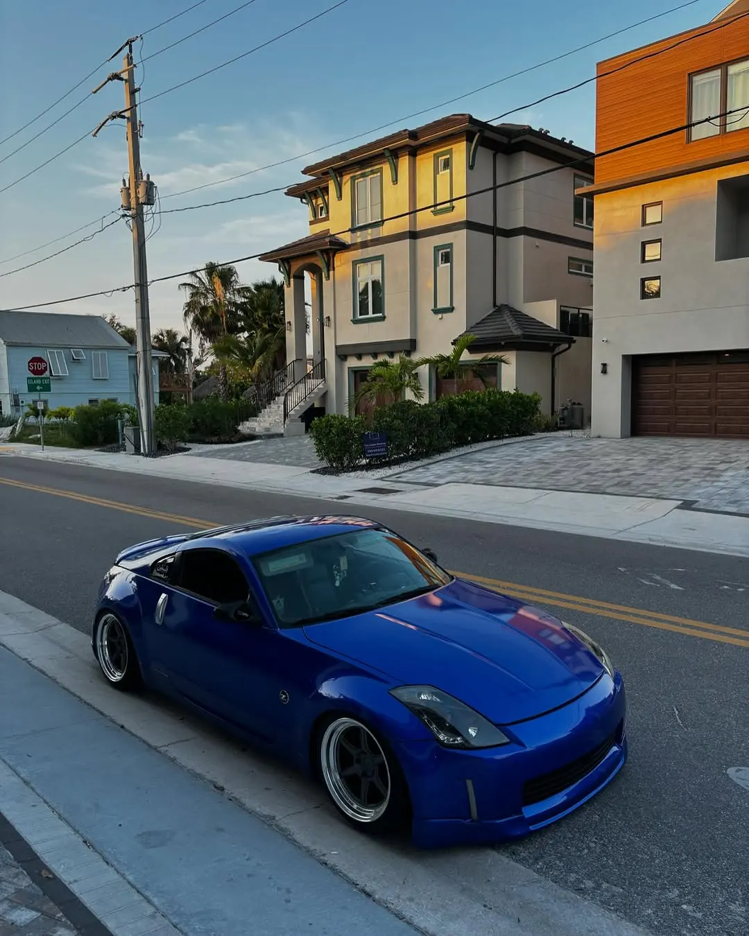 Tarek's blue Nissan 350Z on a neighborhood street at sunset